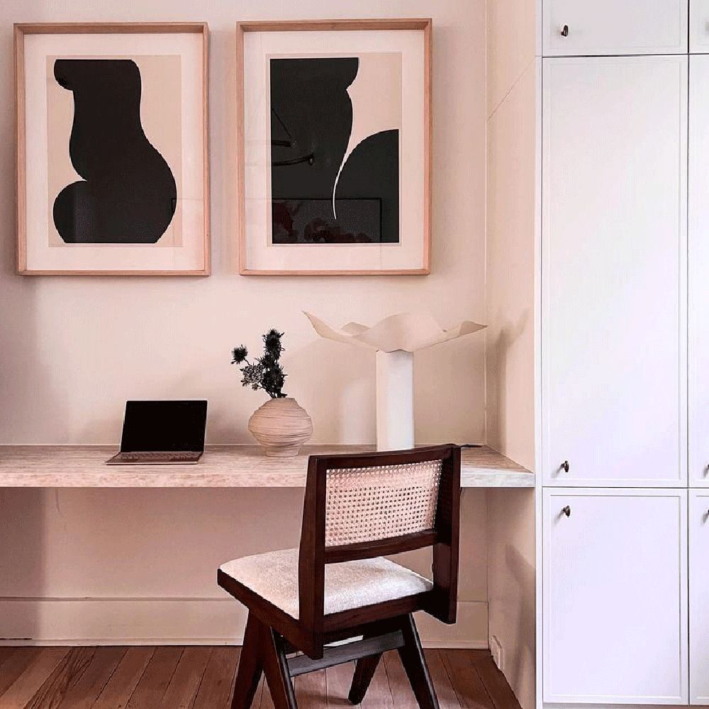 Minimalist home office with marble desk, wooden chair, abstract wall art, and built-in cabinetry – Ren Studio.